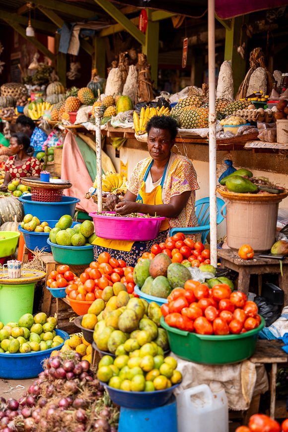 local woman in Uganda on market selling fruit and vegetables