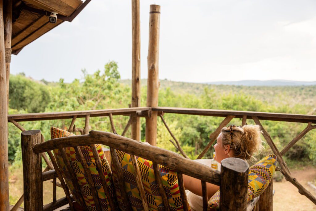 woman relaxing on outside of the lodge