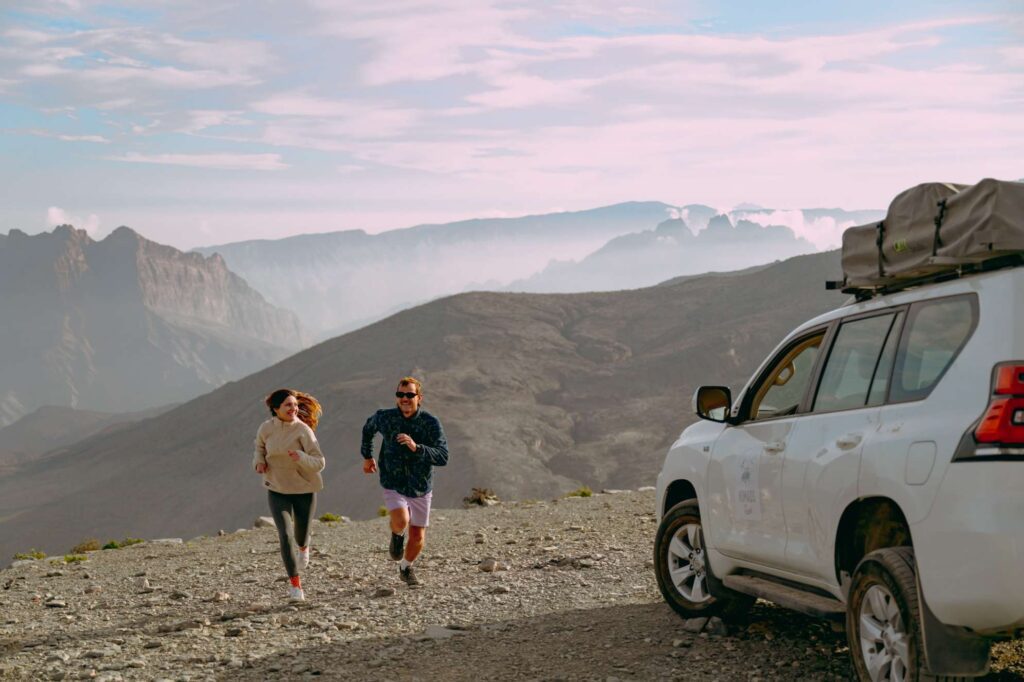Couple running in the mountains in Oman