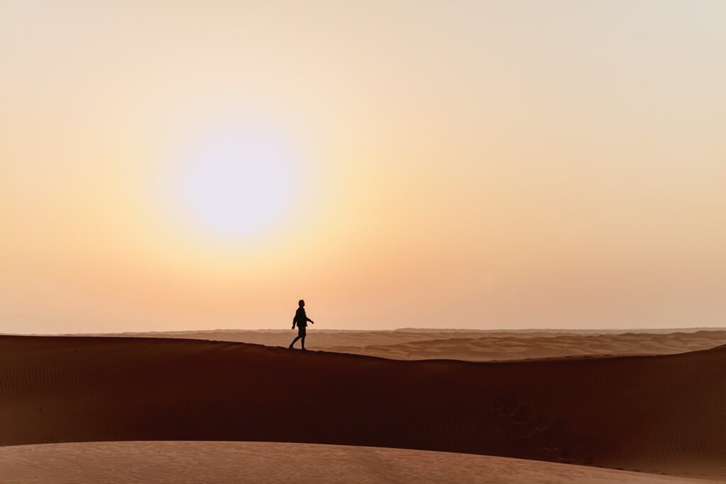 woman walking on the dunes in the Oman desert