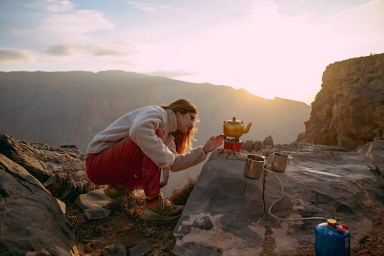 A woman making tea in the mountains.