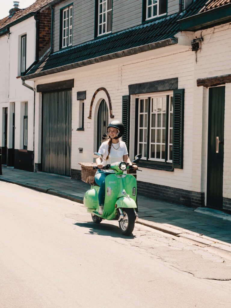 woman riding Vespa in Brugge