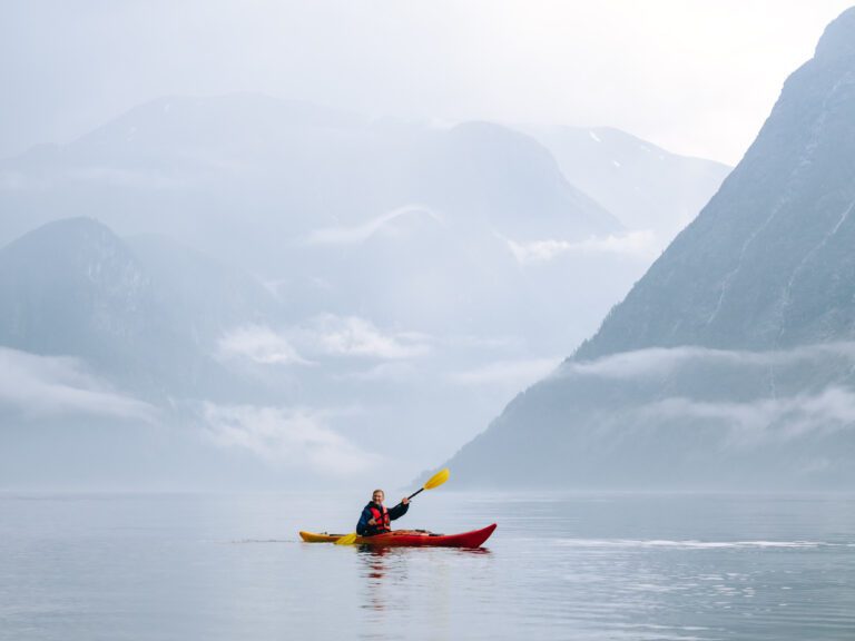 Kayaker with misty view of fjords in Norway - Kayaking - Norway fjord - hiking in Norway - kayaking - from Brussels airport
